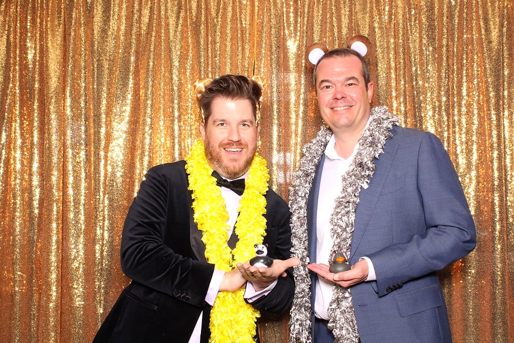 Guests goofing with props at the Posed photo booth, Austin