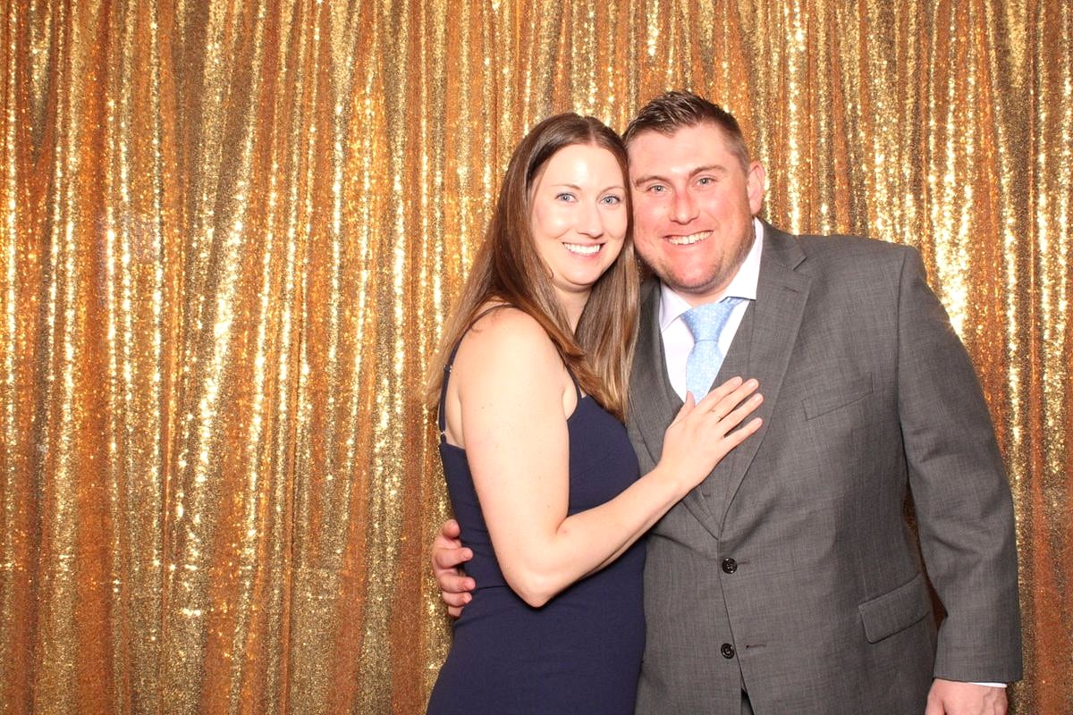 Happy couple sharing a moment at the Posed photo booth, gold sequin backdrop, Austin